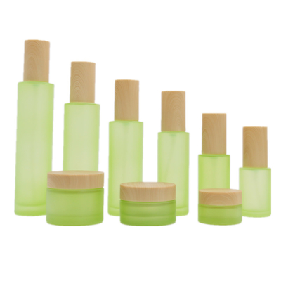 2022 New Skin Care Cosmetic Packaging Spray Lotion Bottle Green Frosted Glass Facial Cream Jar With Wood Grain Cover